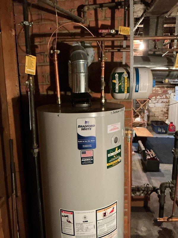 Performed annual maintenance tune-up on one-year-old Bradford White tanked water heater including flush and fill procedure. Accommodated site conditions with drain located approximately 15 feet from unit. Inspected all connections, copper piping, expansion tank, pressure relief valve assembly, and water treatment components; verified proper operation of all systems and left unit in excellent working condition.