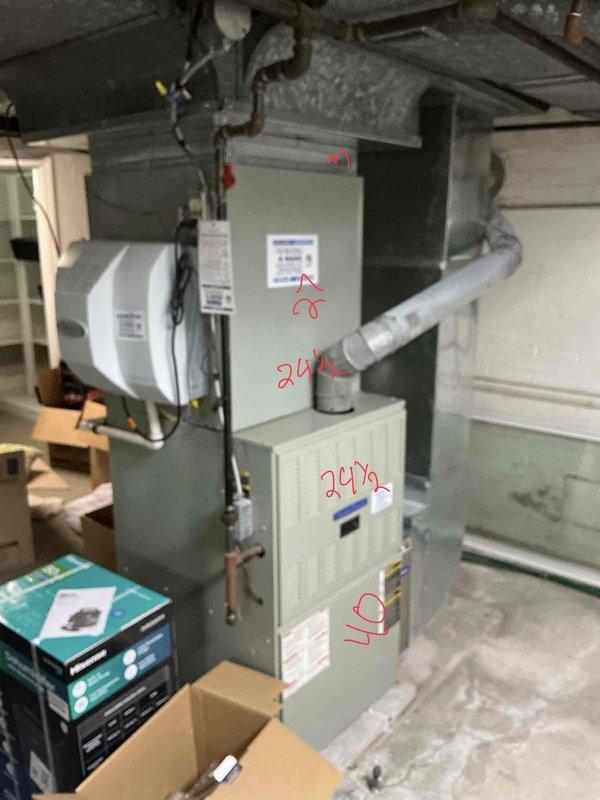 Completed comprehensive HVAC system replacement estimate for residential property equipped with dual air conditioning units, furnace, and heat pump system. Documented existing basement mechanical room installation including gray metal furnace/air handler unit with integrated humidifier, PVC drainage piping, copper refrigerant lines, and associated ductwork infrastructure to provide accurate replacement specifications and equipment sizing recommendations.