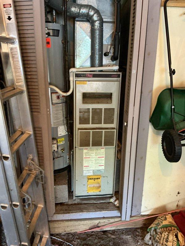 Conducted comprehensive estimate for complete HVAC system replacement including both air conditioning condenser unit and furnace. Evaluated existing outdoor condenser unit located in narrow side yard passageway with heavy leaf accumulation and assessed indoor furnace installation with flexible ductwork in utility closet. Provided detailed quote for full system replacement to upgrade aging equipment and improve heating and cooling efficiency.