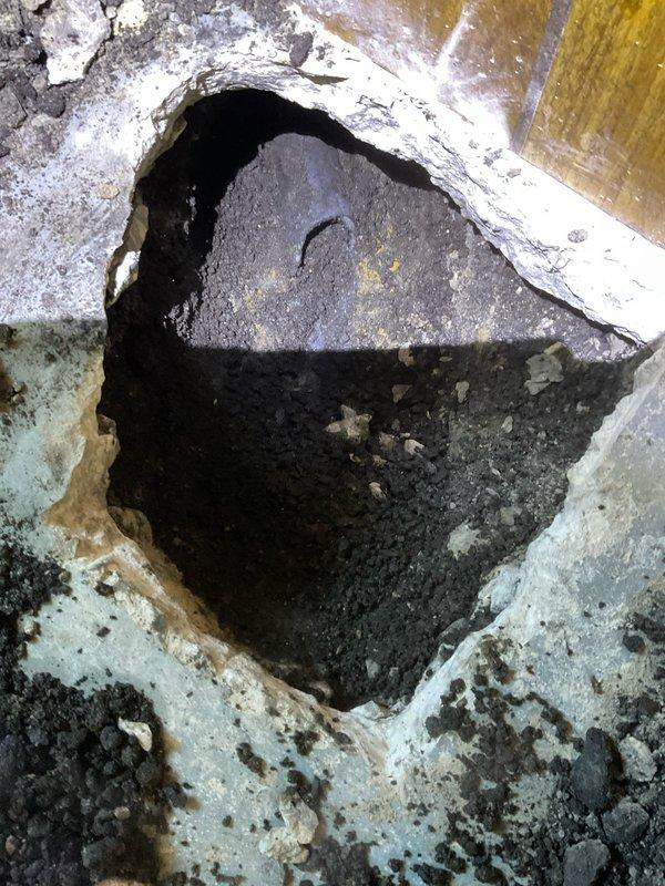 Replaced deteriorated plumbing stack with new PVC pipe where severe concrete floor degradation and water damage had compromised the existing drain system. Installed customer-supplied faucet as part of the repair scope. The work addressed significant structural concerns around the failed stack, with excavation revealing moisture-saturated substrate and compromised flooring material that necessitated complete pipe replacement to restore proper drainage function.