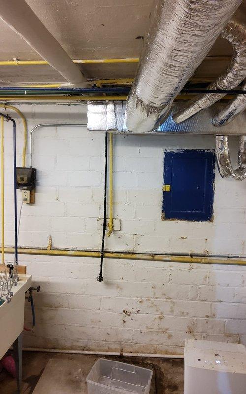 Responded to no cooling complaint at residential property. Upon arrival, conducted system diagnostic and visual inspection of HVAC equipment and ductwork distribution system. Identified active leak in flexible ductwork located in basement utility area, with condensation contributing to minor water accumulation on floor. Inspected exposed mechanical infrastructure including gas lines, copper plumbing connections, and insulated joists for related issues. Documented conditions with photos showing metallic flex duct runs, utility room layout, and areas of concern. Advised customer of ductwork repair requirements to restore proper system operation and prevent continued moisture intrusion.
