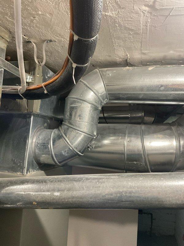 Performed comprehensive duct inspection and airflow assessment to address uneven air distribution throughout multi-story residence. Conducted camera inspection of ductwork system to identify damper positions and potential airflow restrictions in second and third floor supply runs. Inspected basement ductwork installation, evaluated main trunk line connections, and assessed branch duct routing to upper levels. Documented HVAC system configuration including flexible duct connections, refrigerant line placement, and insulation conditions in attic mechanical space. Identified accessible damper locations and provided recommendations for optimizing airflow balance to underperforming vents on upper floors.