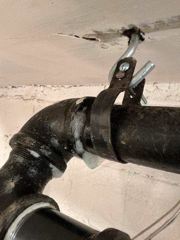 Pressurized entire home plumbing system using air compressor to conduct comprehensive gas leak detection throughout the property. Identified multiple areas requiring attention, including exposed black iron gas piping in basement utility area with visible connections and joints that required inspection. Documented all findings with photographs and provided detailed repair quotation for necessary corrective work to ensure system safety and code compliance.
