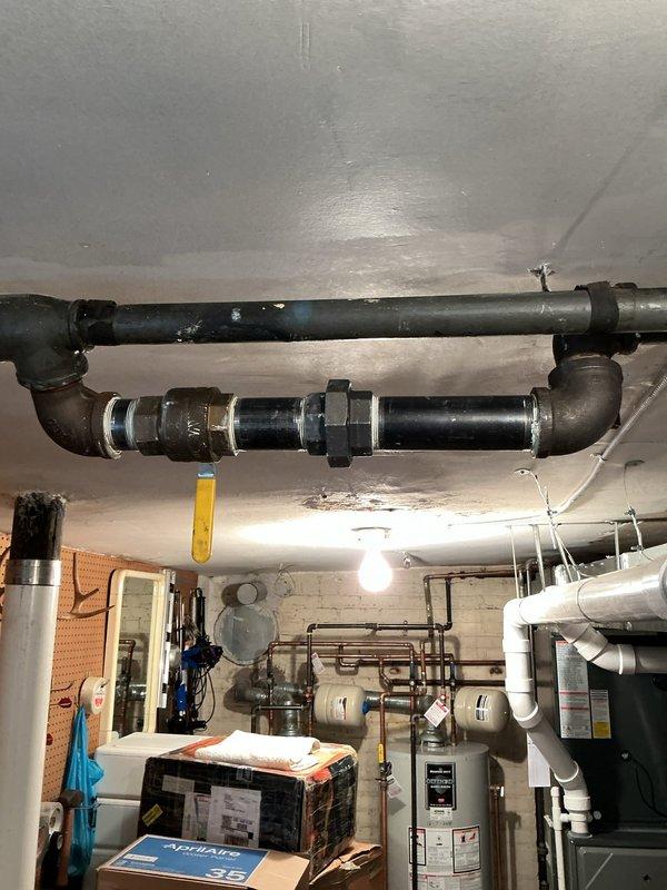 Pressurized entire home plumbing system using air compressor to conduct comprehensive gas leak detection throughout the property. Identified multiple areas requiring attention, including exposed black iron gas piping in basement utility area with visible connections and joints that required inspection. Documented all findings with photographs and provided detailed repair quotation for necessary corrective work to ensure system safety and code compliance.