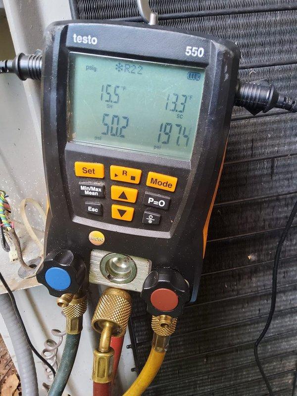 Performed comprehensive seasonal AC tune-up and system diagnostics on residential cooling system that had been dormant since previous summer. Conducted thorough visual inspection of outdoor condensing unit, indoor evaporator coil, and all associated components. Utilized Testo 550 digital manifold gauge to measure and record system operating pressures and temperatures, confirming refrigerant charge levels and system performance parameters. Suction pressure reading of 15.5 psig with corresponding temperature of 13.3°F and high-side pressure of 50.2 psig indicated proper refrigerant charge and system operation. Inspected condenser coil fins for damage or blockage, verified electrical connections at unit, and checked capacitor values. Cleaned condenser coil to ensure optimal heat transfer efficiency. Verified proper compressor amperage draw and operation. Inspected and tested contactor operation and relay functionality. Checked refrigerant line insulation for deterioration. Confirmed prope