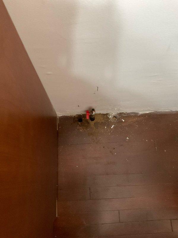 Provided estimate for relocating existing gas line to accommodate stove repositioning. Assessed current gas supply valve location and determined routing requirements for safe installation. Documented existing conditions including wall-mounted shut-off valve and floor layout to plan proper gas line extension and connection points.