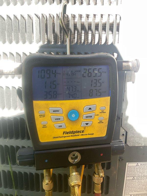 Performed comprehensive cooling system maintenance on 12-year-old residential air conditioning unit. Conducted complete system diagnostics using digital manifold gauges, measuring refrigerant pressures and temperatures across the system. Inspected outdoor condenser unit including electrical components, contactor assembly, and fan operation. Verified proper system operation with measured suction pressure of 109.4 PSI, discharge pressure readings, and operating temperatures of 115°F and 133°F, confirming system is functioning within manufacturer specifications.