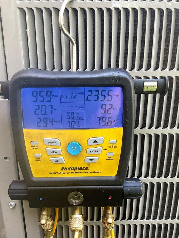 Completed preventive maintenance on a 4-year-old ADP air conditioning system utilizing R410A refrigerant with TXV metering device. Performed system diagnostics using Fieldpiece SMAN manifold gauges, recording operating pressures of 95.9 PSIG suction and 235.5 PSIG discharge with corresponding temperature readings within normal operating range. Inspected condenser coil condition, confirming clean fins and proper airflow, and verified all refrigerant connections and system components for proper operation.