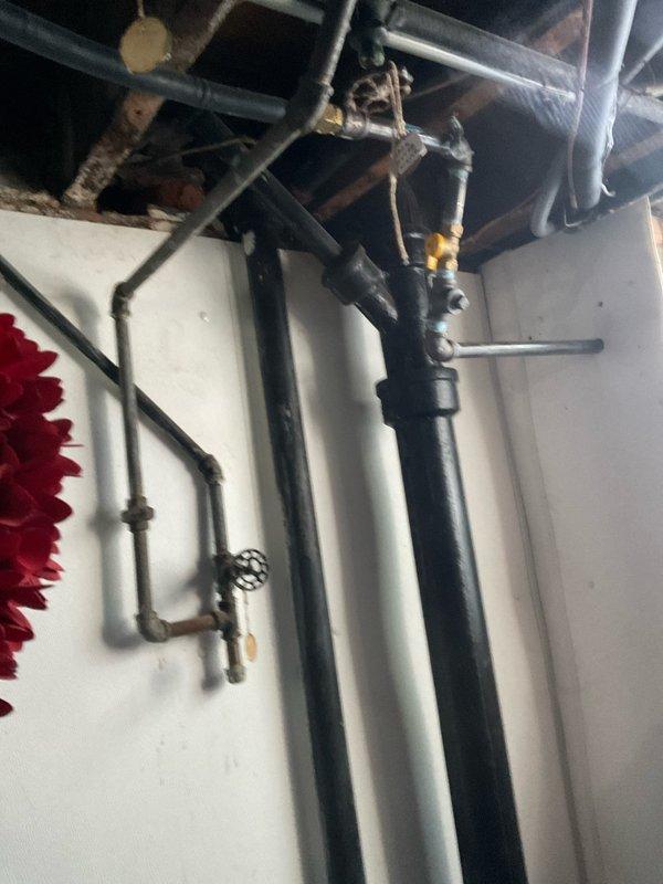 Responded to bathroom sink clog complaint and performed diagnostic assessment. Upon arrival, accessed plumbing system through basement utility area to inspect drainage lines and trap assembly. Identified blockage in drain line, cleared obstruction, and verified proper water flow restoration. System tested and confirmed operational.