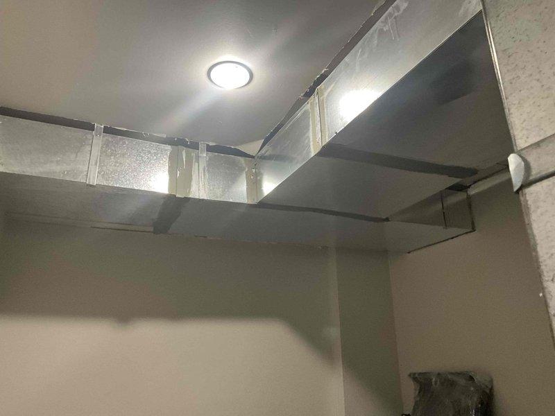 Conducted ductwork estimate and inspection of existing HVAC system in basement utility space. Evaluated rectangular sheet metal ductwork installation, including horizontal runs and angled transitions with proper metal strap support systems. Assessment identified potentially undersized ductwork that may be restricting airflow capacity and reducing system efficiency. Documented current ductwork configuration, support mechanisms, and connection points with photographic evidence for estimate preparation.