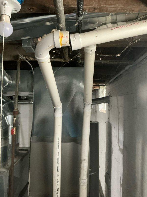 Responded to service call for non-operating AC condenser fan and potential carbon monoxide concern with water heater venting identified in buyer's inspection report. Accessed vacant property using provided lockbox code and conducted thorough evaluation of both systems. Inspected outdoor AC condenser unit and confirmed fan motor failure; assessed electrical connections, capacitor, and control board for proper diagnosis. Examined one-year-old water heater installation in basement, specifically evaluating vent pipe configuration, combustion air supply, and proper draft conditions. Photographed water heater venting system showing PVC exhaust piping and overall installation setup for documentation purposes. Verified all plumbing connections, expansion tank, and safety components on water heater were properly installed per manufacturer specifications. Provided comprehensive assessment findings to facilitate resolution of both issues prior to property sale closing.