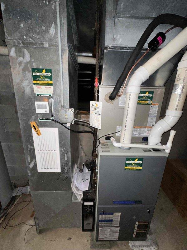 Completed full 3-ton air conditioning system replacement. Removed existing outdoor condensing unit and installed new 3-ton A/C system with associated refrigerant line set. Removed obsolete humidifier from existing ductwork and properly patched opening to restore system integrity. Connected new refrigerant lines with white foam insulation to indoor air handler unit. Verified proper electrical connections and control wiring between components. Tested system operation and confirmed supply air temperature of 45°F at register, indicating proper refrigerant charge and cooling performance. System commissioned and left in operational condition.