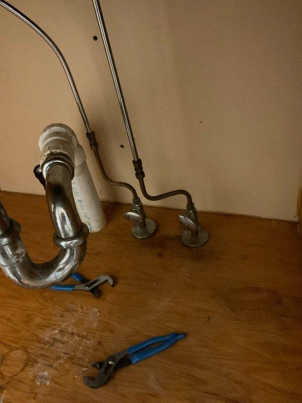 Returned to property to complete installation of customer-supplied kitchen faucet and pull-out spray assembly. Successfully installed single-handle chrome faucet with braided supply lines, connected P-trap drain assembly, and tested all connections for proper operation and leak-free performance.