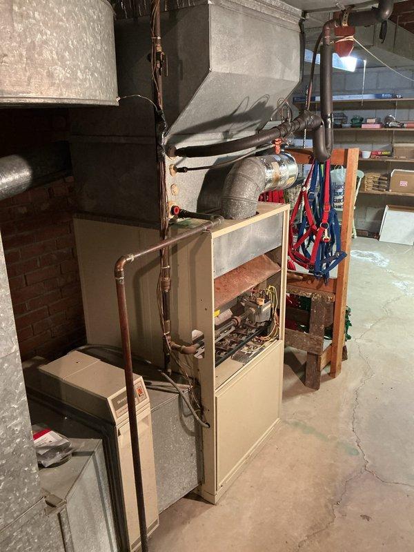 Completed comprehensive HVAC system replacement estimate for residential property in response to promotional inquiry. Assessed existing outdoor air conditioning condenser unit and indoor furnace system, documented current equipment conditions including refrigerant line routing, electrical connections, and ductwork configuration. Evaluated basement mechanical room layout with existing furnace, ductwork, and associated plumbing components to provide accurate replacement specifications and installation requirements for complete heating and cooling system upgrade.