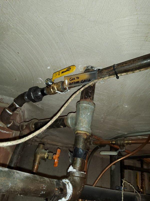 Replaced existing half-inch grease valve with a ball valve on the gas line serving the stove, removed a secondary grease valve, and properly capped the 3/8-inch line. Following the modifications, performed a comprehensive pressure test on the gas system to verify integrity and confirm no leaks were present at any connections or joints.