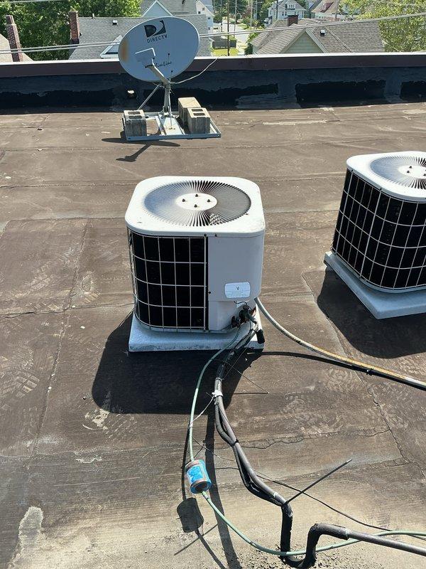 Completed HVAC estimate for unit #9 replacement at commercial property. Assessed existing Concord furnace system in basement mechanical room with connected ductwork network and evaluated rooftop air conditioning condenser units requiring replacement. Documented current equipment conditions, photographed existing installations including basement heating system with extensive metal ductwork and rooftop commercial AC units, and provided replacement recommendations for aging HVAC equipment.