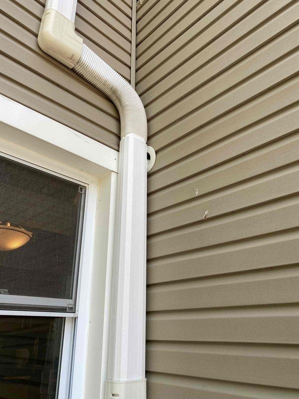 Responded to service call for three-year-old mini split air conditioning system not cooling properly. Upon arrival, performed diagnostic inspection of both indoor and outdoor units. Inspected refrigerant line set, condensate drainage system, and electrical connections visible at exterior installation. Verified proper operation of condensate drain line and checked for any visible obstructions or damage to refrigerant lines running along building exterior. Evaluated outdoor unit mounting and line set routing for any potential issues affecting system performance. Documented equipment condition with photographs showing exterior components including line set installation, utility disconnect box, and condensate drain configuration.