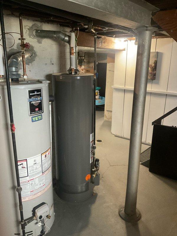 Conducted complimentary water heater estimate in residential basement for potential replacement of existing unit. Assessed current dual water heater configuration and discussed sizing options with homeowner, including possibility of upgrading to 80-gallon capacity tank to meet household hot water demand requirements. Documented existing plumbing connections, copper supply lines, shut-off valves, and current installation layout for preparation of replacement proposal.