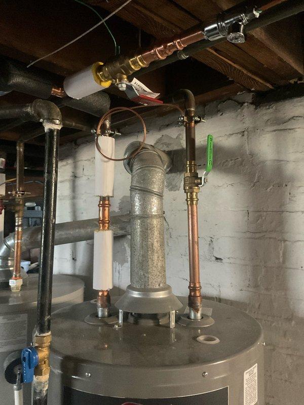 Conducted complimentary water heater estimate in residential basement for potential replacement of existing unit. Assessed current dual water heater configuration and discussed sizing options with homeowner, including possibility of upgrading to 80-gallon capacity tank to meet household hot water demand requirements. Documented existing plumbing connections, copper supply lines, shut-off valves, and current installation layout for preparation of replacement proposal.