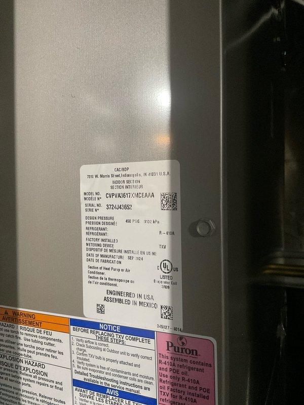 Completed spring maintenance on a one-year-old Carrier R-410A cooling system. Performed comprehensive system diagnostics using refrigerant manifold gauges, recording operating pressures of 112.1 PSIG suction and 306.8 PSIG discharge with temperature differentials within normal parameters. Inspected condenser coil condition, verified proper refrigerant charge levels, and confirmed all manufacturer specifications and safety labels were intact and legible on the outdoor unit.