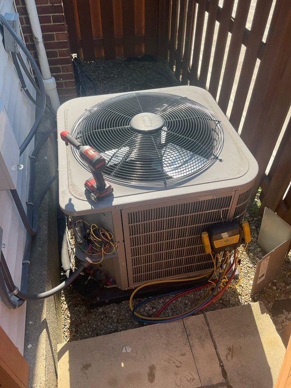 Performed comprehensive spring preventative maintenance on 2-year-old residential air conditioning system. Conducted complete system evaluation using digital manifold gauge set to measure refrigerant pressures and temperatures across the system. Recorded superheat and subcooling calculations to verify proper refrigerant charge levels. All readings indicated optimal system performance with no refrigerant loss or leaks detected.

Inspected outdoor condenser unit positioned in side yard location. Examined condenser coil fins for damage, debris, and airflow restrictions. Verified proper fan motor operation and blade condition. Checked electrical connections at disconnect panel and unit terminals for tightness and signs of overheating. Measured voltage and amperage draw on compressor and fan motor, confirming values within manufacturer specifications.

Connected refrigerant manifold gauges to service ports and monitored system operating pressures under ambient conditions. High-side and low-