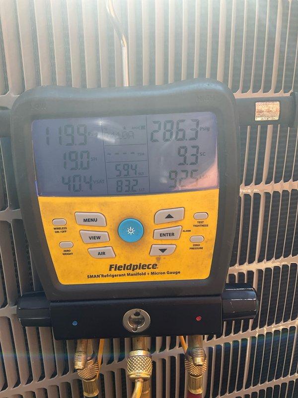 Performed comprehensive spring preventative maintenance on 2-year-old residential air conditioning system. Conducted complete system evaluation using digital manifold gauge set to measure refrigerant pressures and temperatures across the system. Recorded superheat and subcooling calculations to verify proper refrigerant charge levels. All readings indicated optimal system performance with no refrigerant loss or leaks detected.

Inspected outdoor condenser unit positioned in side yard location. Examined condenser coil fins for damage, debris, and airflow restrictions. Verified proper fan motor operation and blade condition. Checked electrical connections at disconnect panel and unit terminals for tightness and signs of overheating. Measured voltage and amperage draw on compressor and fan motor, confirming values within manufacturer specifications.

Connected refrigerant manifold gauges to service ports and monitored system operating pressures under ambient conditions. High-side and low-