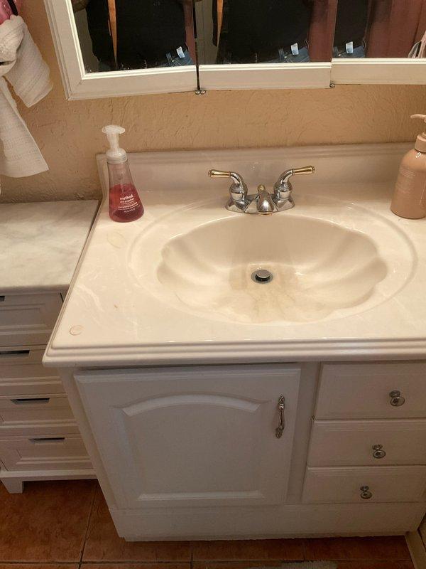 Responded to service call for leaky toilet in 1963-built residence. Upon arrival, conducted thorough inspection of bathroom plumbing fixtures and identified source of water leak at toilet base. Assessed wax ring seal integrity and flange connection, finding deterioration consistent with age of home and fixture. Shut off water supply at angle stop valve and drained toilet tank and bowl completely. Removed toilet mounting bolts and carefully lifted fixture to access flange and existing wax ring. Cleaned flange surface and removed old wax ring residue from both toilet base and floor flange. Inspected closet flange for cracks or damage, confirmed structural integrity adequate for reinstallation. Installed new wax ring with proper alignment and repositioned toilet onto flange, ensuring even seating. Secured toilet with new brass mounting bolts and tightened evenly to manufacturer specifications to prevent rocking or future seal compromise. Reconnected water supply line at tank fill valve an