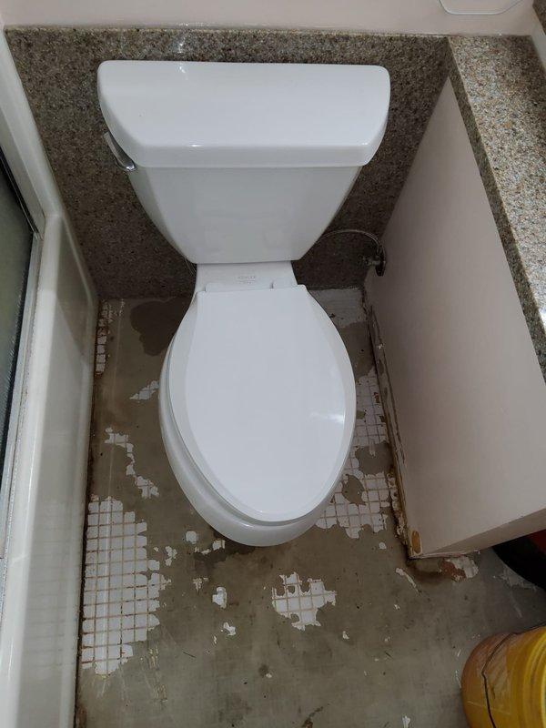 Replaced deteriorated wax ring seal on toilet in 45-year-old residential property. Upon arrival, identified failed wax ring as source of leak, evidenced by extensive water damage and tile deterioration on bathroom floor. Removed toilet from flange, scraped away old wax ring remnant, inspected flange for structural integrity, and installed new wax ring. Properly reseated and secured toilet to floor, reconnected water supply, and tested for leaks. Documented pre-existing floor damage including missing mosaic tiles, exposed substrate, and rust staining around nearby drain fixture for homeowner awareness.