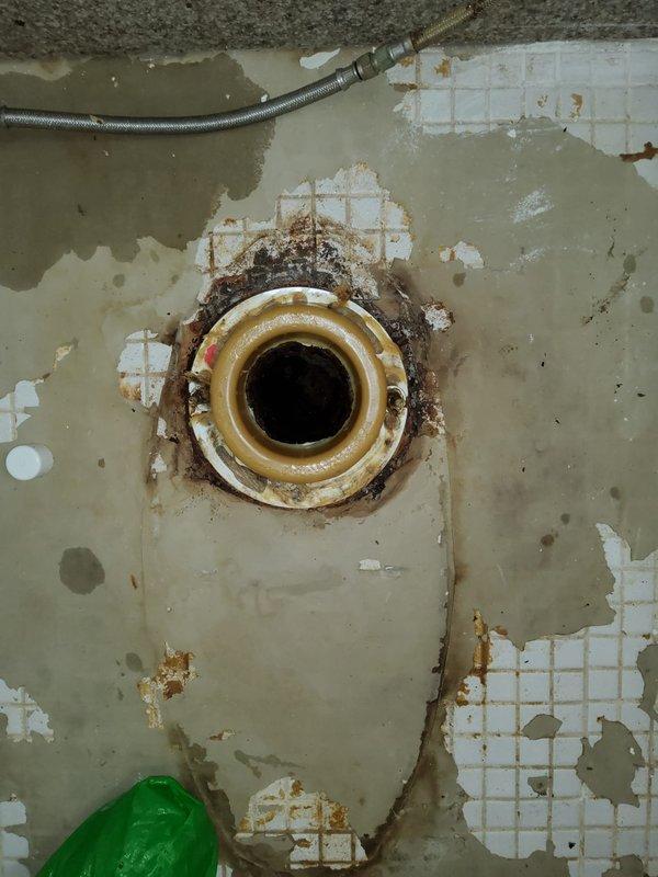 Replaced deteriorated wax ring seal on toilet in 45-year-old residential property. Upon arrival, identified failed wax ring as source of leak, evidenced by extensive water damage and tile deterioration on bathroom floor. Removed toilet from flange, scraped away old wax ring remnant, inspected flange for structural integrity, and installed new wax ring. Properly reseated and secured toilet to floor, reconnected water supply, and tested for leaks. Documented pre-existing floor damage including missing mosaic tiles, exposed substrate, and rust staining around nearby drain fixture for homeowner awareness.