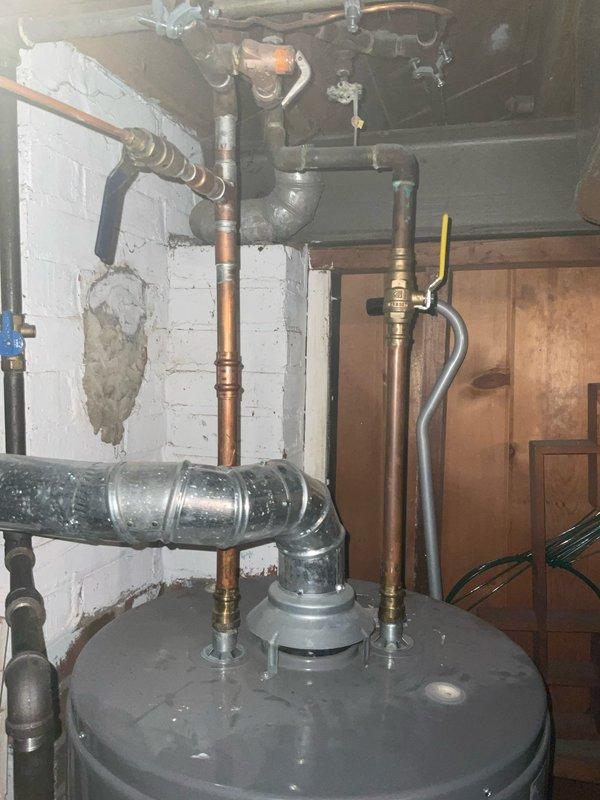 Performed comprehensive plumbing inspection of water heater system, focusing on expansion tank and pressure/temperature relief valve. Evaluated existing plumbing configuration including copper supply lines, connection fittings, and safety valve operation. Documented current condition of water heater assembly, associated piping infrastructure, and proper installation of thermal expansion components to ensure system compliance and safe operation.