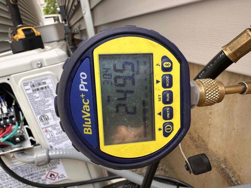 Completed mini split installation for upstairs bedroom. System was properly evacuated using digital vacuum gauge to ensure proper refrigerant charge, and electrical connections were verified with voltage testing equipment showing 115V supply. Unit commissioned and confirmed operational.