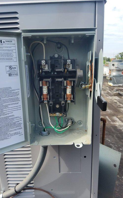 Responded to no-cooling call on rooftop Carrier WeatherMaker unit. Upon arrival, inspected electrical disconnect box and found blown fuses in the contactor assembly, which caused the unit to stop cooling earlier in the day. Replaced damaged fuses, verified proper electrical connections, and restored unit to normal operation with cooling confirmed.