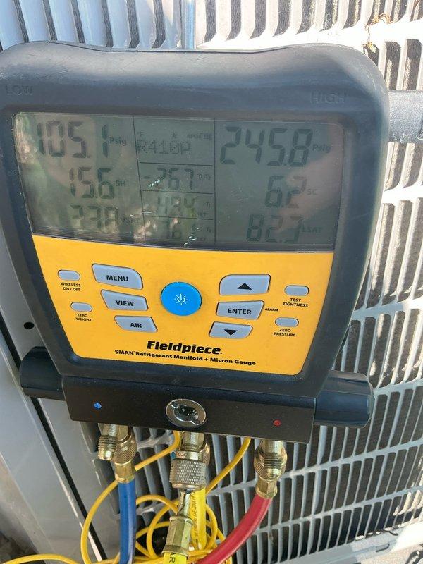 Performed annual maintenance on a 1-year-old air conditioning system. Inspected blower wheel assembly for cleanliness and proper operation, verified all components were secure and functioning correctly. Connected refrigerant manifold gauges to measure system pressures and temperatures, confirmed operating pressures within manufacturer specifications at 405.1 PSIG high side and 138 PSIG low side with corresponding temperatures of 156°F and 54°F respectively. System operating efficiently with no issues found.