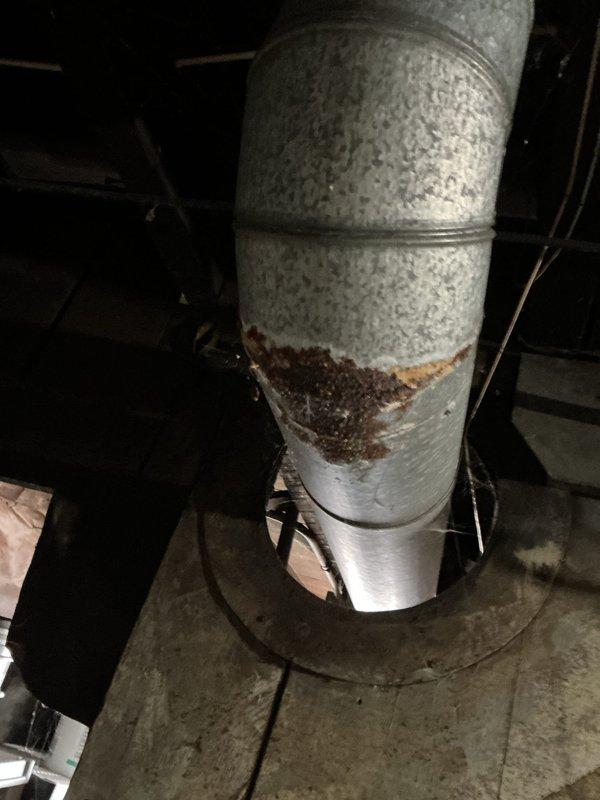 Completed on-site ductwork assessment for estimate purposes. Inspection revealed galvanized metal supply ductwork in basement/crawl space with significant corrosion and rust deterioration on lower sections of vertical duct run, indicating moisture intrusion and metal degradation requiring replacement. Documented existing HVAC distribution system configuration including rectangular trunk lines and cylindrical branch ducts. Photographed compromised ductwork sections showing rust perforation and structural compromise at connection points. Provided comprehensive evaluation of ductwork condition to determine scope of repair versus replacement recommendations for customer decision.