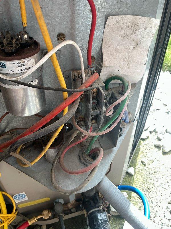 Completed comprehensive air conditioning tune-up on outdoor condensing unit of unknown age. Performed standard maintenance procedures including inspection of electrical connections, capacitor testing, refrigerant line examination, and overall system evaluation. Unit showed signs of age with visible oxidation on metal components and weathered wiring, but all connections were verified secure and system operational upon completion.
