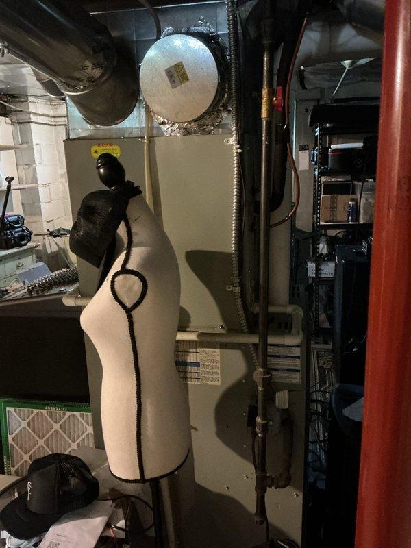 Conducted comprehensive HVAC system assessment for air conditioning replacement estimate on 16-year-old equipment. Documented existing furnace and ductwork configuration in basement mechanical room, photographed current system layout including cylindrical ductwork connections and equipment positioning. Provided replacement options and recommendations based on system age and operational efficiency requirements.