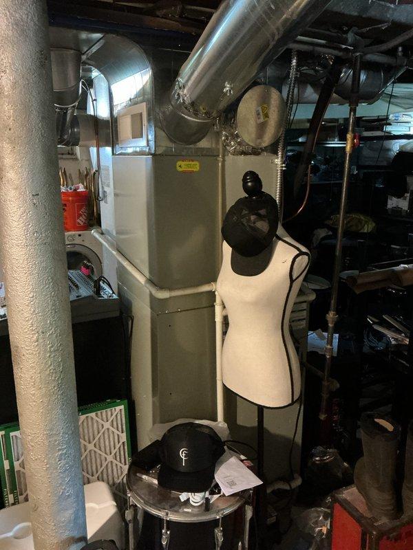 Conducted comprehensive HVAC system assessment for air conditioning replacement estimate on 16-year-old equipment. Documented existing furnace and ductwork configuration in basement mechanical room, photographed current system layout including cylindrical ductwork connections and equipment positioning. Provided replacement options and recommendations based on system age and operational efficiency requirements.