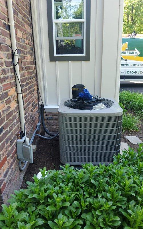 Responded to no-cooling call on a one-year-old residential air conditioning system. Upon inspection, diagnosed a failed dual-run capacitor preventing compressor and condenser fan operation. Replaced defective capacitor with proper 40/5 MFD unit, verified all electrical connections, and tested system for proper operation with normal cooling restored.