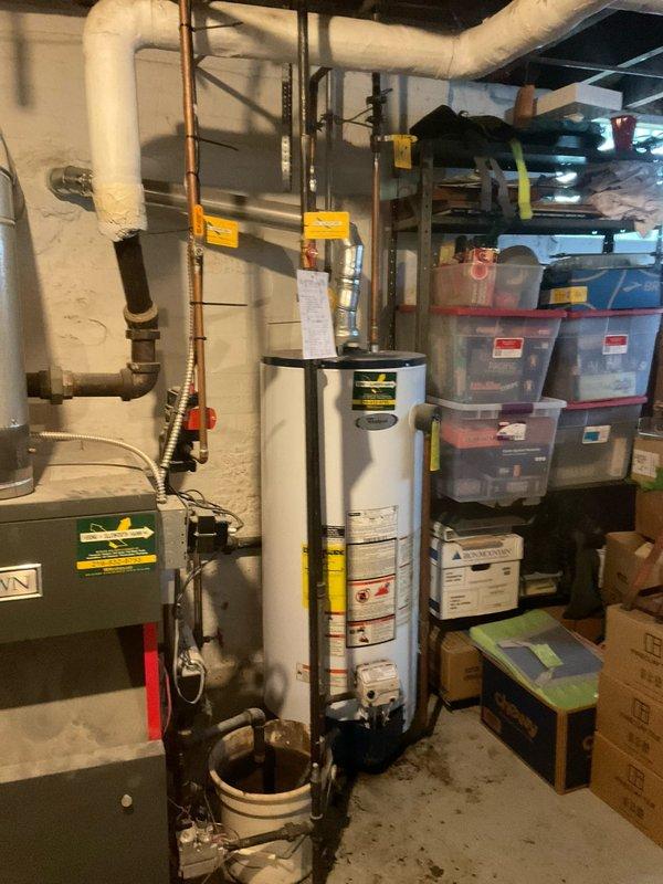 Responded to emergency water heater failure and provided estimate for replacement of failed tanked hot water heater unit. Upon inspection, found existing water heater had catastrophically failed in basement mechanical room. Documented current installation configuration including copper supply lines, gas connections, and venting system. Assessed surrounding plumbing infrastructure and clearances for new unit installation. Photographed failed equipment and existing piping arrangement to prepare accurate replacement estimate for customer approval.