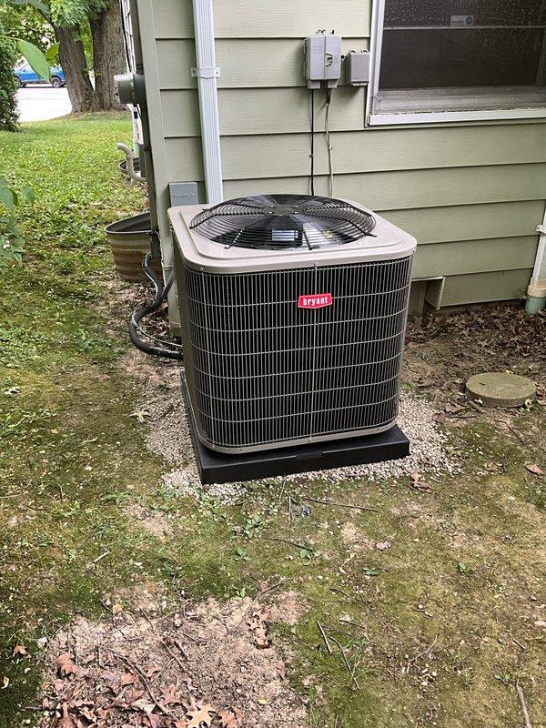 Completed full HVAC system installation including outdoor Bryant condenser unit mounted on new black plastic pad alongside exterior of residence. Installed new indoor evaporator coil in basement mechanical room, positioned adjacent to existing air handler unit. Ran refrigerant lines connecting outdoor condenser to indoor evaporator coil with proper insulation and securing. Installed new electrical disconnect box on exterior wall with conduit running from house to outdoor unit, ensuring all electrical connections meet code requirements. Added PVC condensate drain lines for proper moisture removal from system. Installed new programmable thermostat to provide enhanced temperature control and energy efficiency. Verified all refrigerant connections are secure, tested electrical components for proper voltage and amperage, and confirmed system operates within manufacturer specifications. All equipment properly labeled with safety and operational information.