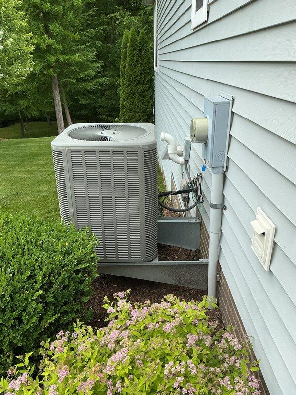 Completed comprehensive HVAC system replacement estimate for residential property. Assessment included evaluation of existing outdoor condensing unit, indoor air handler installation in basement utility area, and associated ductwork modifications. Documented current system configuration including metal supply plenum with mixed silver and beige finish sections, cylindrical branch ductwork, and exterior condensing unit mounted on concrete pad with PVC condensate drainage and electrical disconnect properly installed per code requirements.
