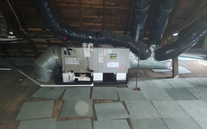 Responded to cooling complaint on recently installed HVAC system with inadequate upstairs cooling performance. Performed comprehensive system inspection of attic-mounted air handler and outdoor condensing unit. Verified proper refrigerant charge, airflow measurements, and ductwork connections throughout the system. Confirmed all equipment labels, certifications, and manufacturer specifications were intact and properly displayed. System tested and operating within normal parameters upon completion of service call.