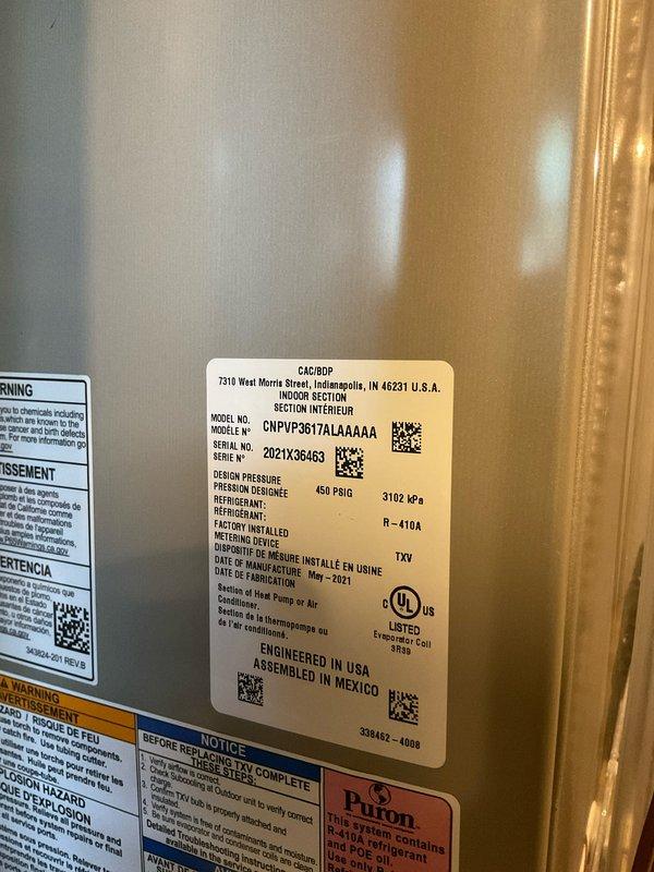 Completed comprehensive air conditioning tune-up on 5-year-old Goodman condensing unit (Model: CNPVP3617ALAAAAA, Serial: 2021X36463) utilizing R-410A refrigerant. Verified system pressures and temperatures using calibrated manifold gauge, confirming operating pressures at 99 psig low side and 335 psig high side with appropriate superheat and subcooling readings. System found operating within normal parameters with no deficiencies noted.