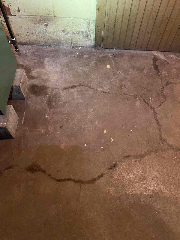 Responded to boiler leak complaint at residential property. Upon arrival, conducted visual inspection of boiler system and surrounding area. Documented evidence of active water leakage with significant moisture damage visible on basement floor, showing extensive dark staining patterns on concrete surface indicating prolonged water infiltration. Copper piping system inspected along with wall-mounted thermostat displaying normal operation at 82 degrees. Photographed affected areas including damaged flooring and water stains for documentation purposes. Customer unavailable during scheduled midday window, limiting ability to perform comprehensive diagnostics or immediate repairs. System requires follow-up visit to identify exact leak source and complete necessary repairs once customer availability confirmed.