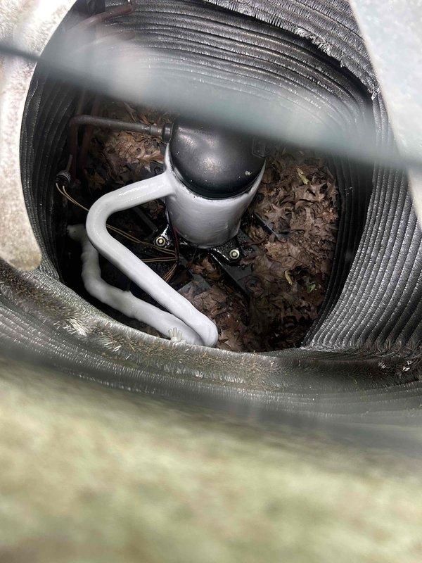Responded to air conditioning service call for 5-year-old system with reported operational issues. Upon inspection, discovered significant debris accumulation including dried leaves and organic matter collected inside the air handler unit, which was restricting airflow and potentially impacting system performance. Inspected exterior refrigerant line insulation along foundation and noted deteriorated sections exposing underlying material, which could lead to efficiency loss and condensation issues. Cleaned debris from air handler housing and interior components to restore proper airflow. Documented existing insulation damage on exterior refrigerant lines for future maintenance consideration.