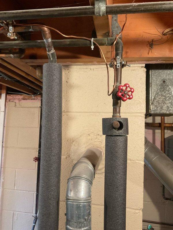 Conducted comprehensive evaluation of existing 40-gallon US Craftmaster natural gas water heater in basement utility area. Documented current unit specifications, including model and serial numbers, BTU ratings, and manufacturing information. Assessed existing plumbing configuration with red gate valve, insulated supply lines, and copper piping connections to provide accurate replacement estimate and installation requirements.