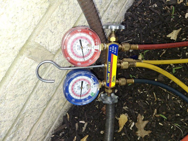 Performed comprehensive air conditioning tune-up on a fifteen-year-old system that was operating without issues. Inspected and evaluated the air filter, which showed moderate dust and dirt accumulation throughout the pleated media, indicating normal use over its service period. Connected manifold gauge set to measure system pressures and verify refrigerant charge levels, confirming the unit was functioning within proper operating parameters.