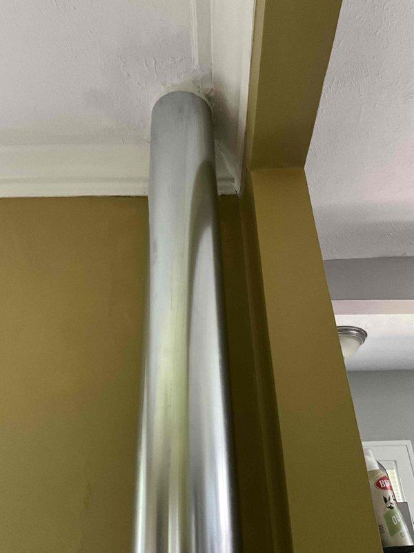 Conducted site assessment for ductwork replacement estimate. Evaluated existing vertical supply duct run extending from ceiling to floor level, noting current metallic duct installation along interior wall corner. Documented duct configuration, connection points, and spatial constraints for preparation of replacement estimate. Customer requested pricing for rerouting at least one duct run to improve system performance.