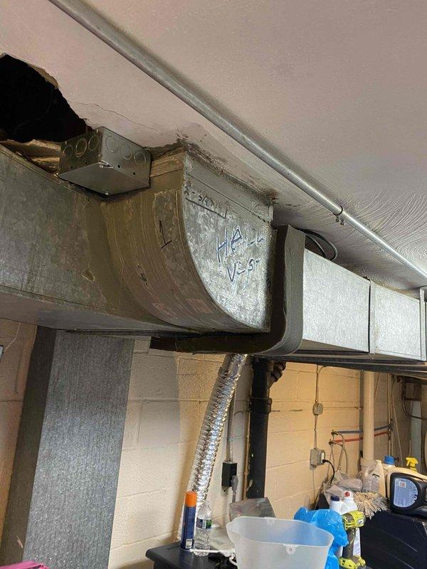 Responded to service call for non-functional Arzel zoning system. Upon inspection, discovered damaged ductwork and compromised ceiling penetration at main trunk line junction in basement utility area. Troubleshot system components, identified communication failure between zone control panel and motorized dampers, and assessed structural damage to duct connection points requiring repair to restore proper zone control functionality.