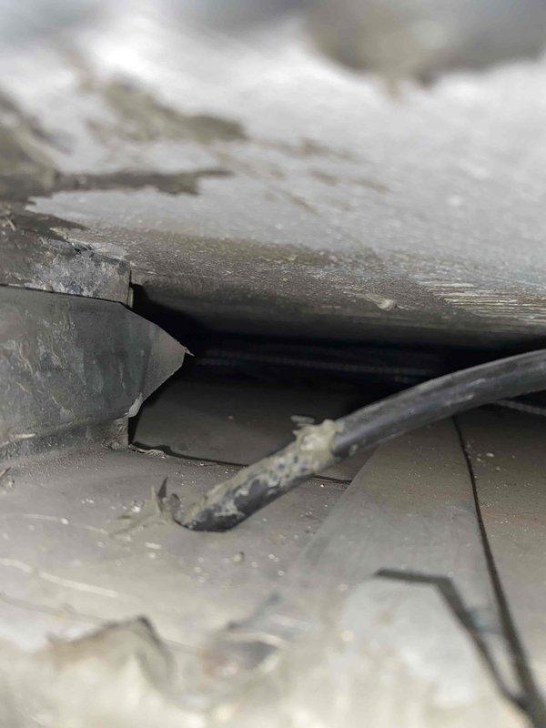 Responded to service call for non-functional Arzel zoning system. Upon inspection, discovered damaged ductwork and compromised ceiling penetration at main trunk line junction in basement utility area. Troubleshot system components, identified communication failure between zone control panel and motorized dampers, and assessed structural damage to duct connection points requiring repair to restore proper zone control functionality.